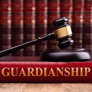 A book on guardianship and a gavel on a wooden table - Legal Advantage Group
